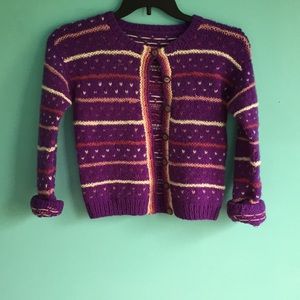 Purple button up sweater.